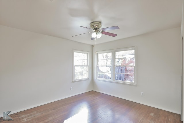 spare room featuring dark hardwood / wood-style floors and ceiling fan