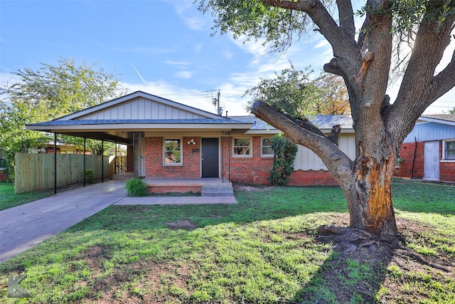 view of front of property with a carport and a front lawn