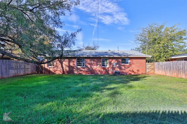 rear view of house with a yard