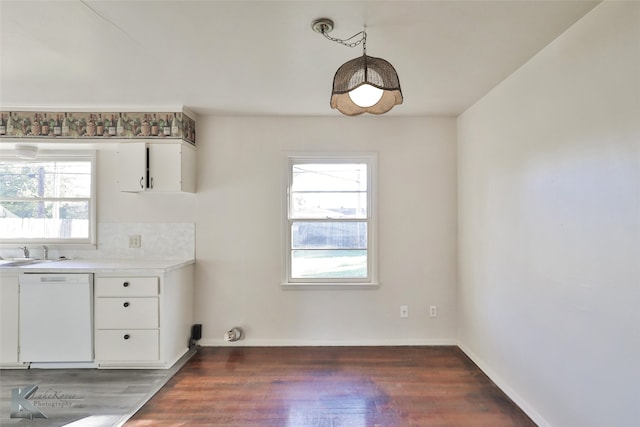 unfurnished dining area with dark hardwood / wood-style floors and sink