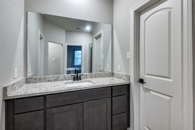 7609 Duck Bay Rd, Fort Worth, TX 76120 - bathroom with vanity and a textured wall