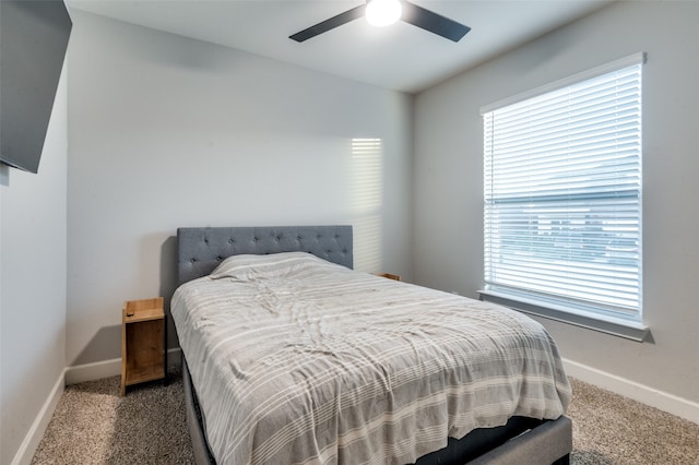 bedroom with ceiling fan and dark carpet