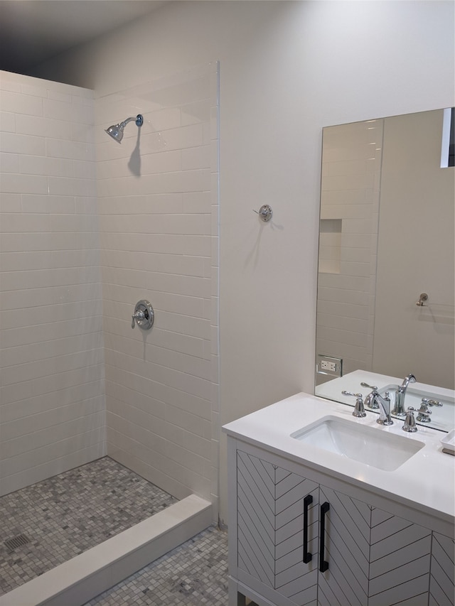 bathroom featuring tile patterned floors, vanity, and tiled shower