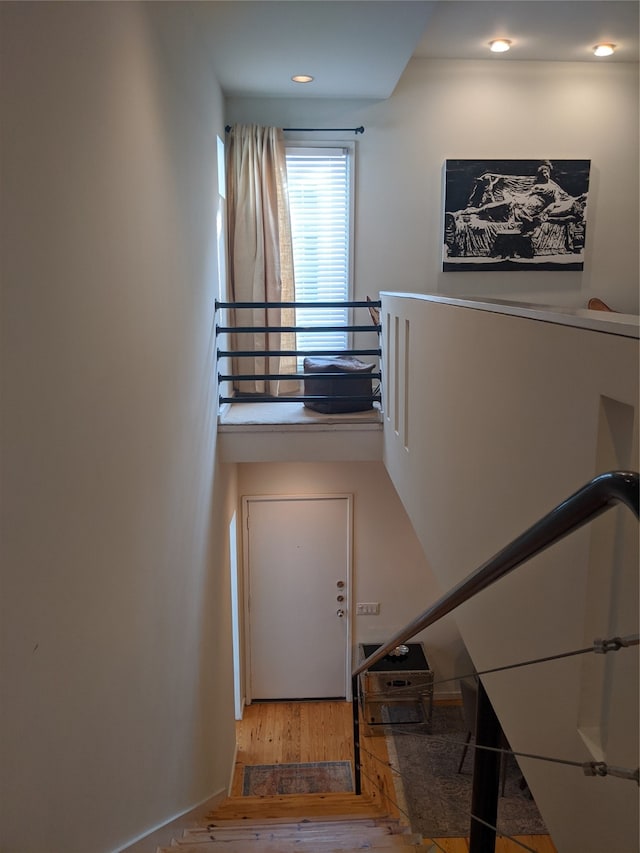 stairs with hardwood / wood-style floors