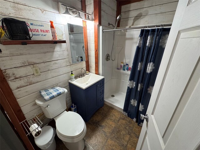 bathroom with vanity, curtained shower, toilet, and wooden walls