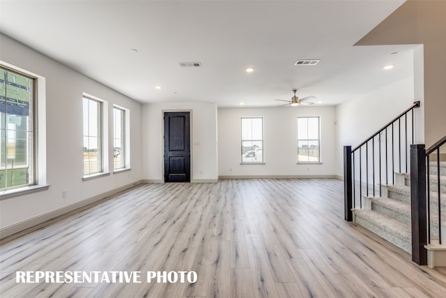 unfurnished living room with ceiling fan and light hardwood / wood-style flooring