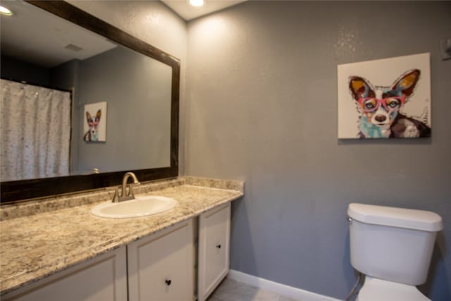 bathroom with tile patterned floors, vanity, and toilet