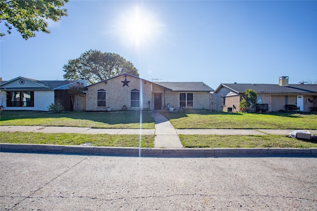 single story home featuring a front yard