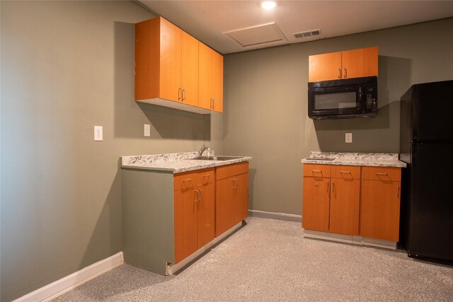 kitchen with black appliances, light colored carpet, and sink