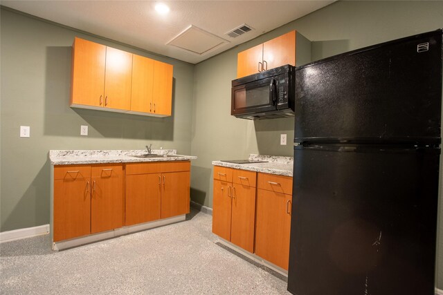 kitchen featuring light carpet, sink, and black appliances