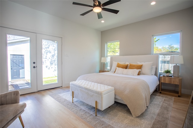 bedroom featuring ceiling fan, access to exterior, light wood-type flooring, and french doors