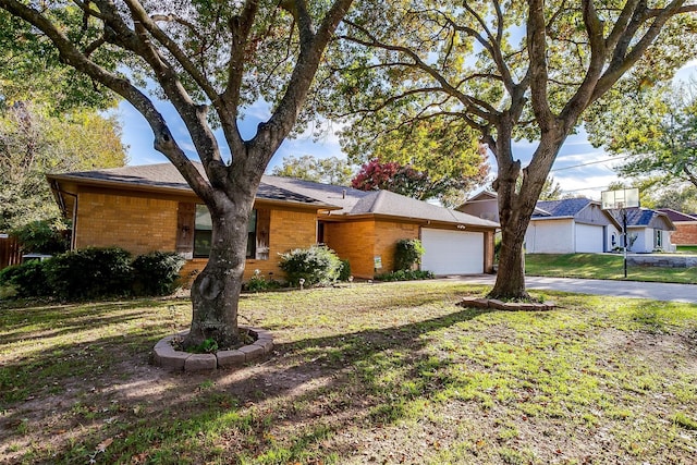 single story home featuring a garage and a front lawn