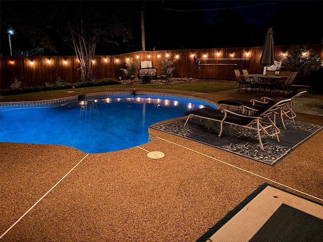 pool at night with a patio