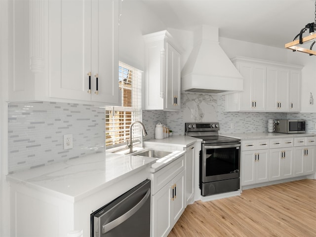 kitchen featuring custom range hood, stainless steel appliances, white cabinetry, and sink