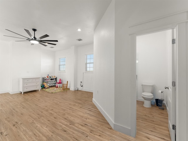 recreation room with ceiling fan and light hardwood / wood-style floors