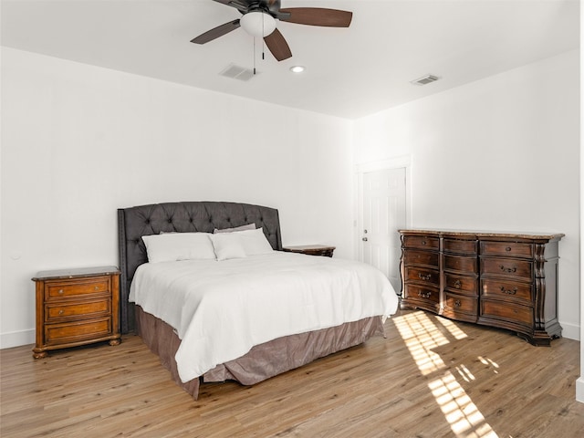 bedroom with ceiling fan and light hardwood / wood-style flooring