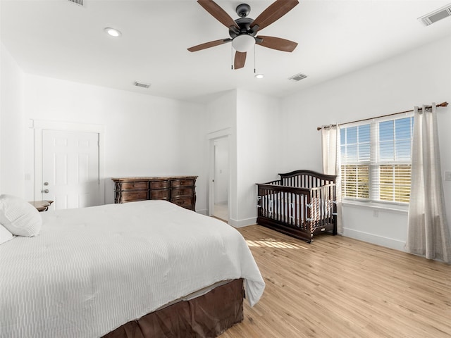 bedroom with hardwood / wood-style floors and ceiling fan