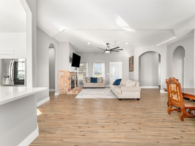 living room with ceiling fan and light hardwood / wood-style floors