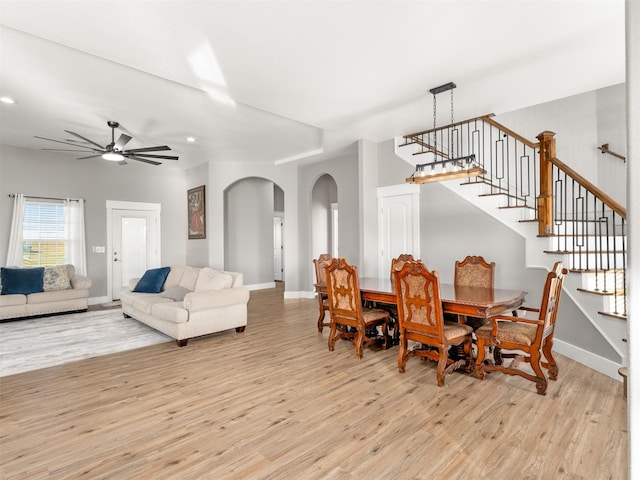 dining space with light hardwood / wood-style flooring and ceiling fan