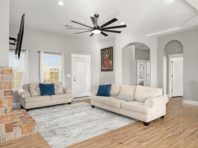 living room featuring hardwood / wood-style floors and ceiling fan