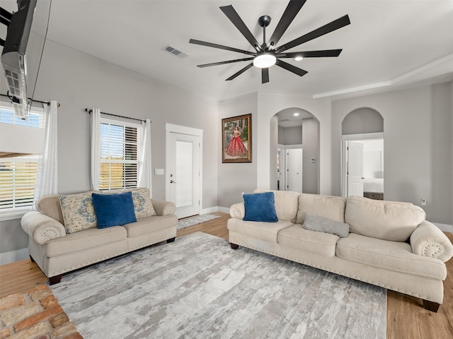 living room with ceiling fan and light hardwood / wood-style floors