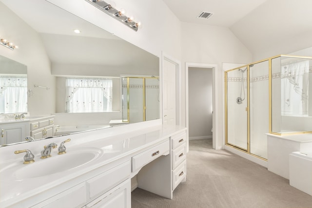 bathroom featuring vanity, a shower with shower door, and lofted ceiling