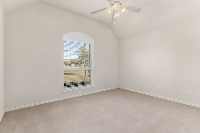 carpeted empty room with ceiling fan and lofted ceiling