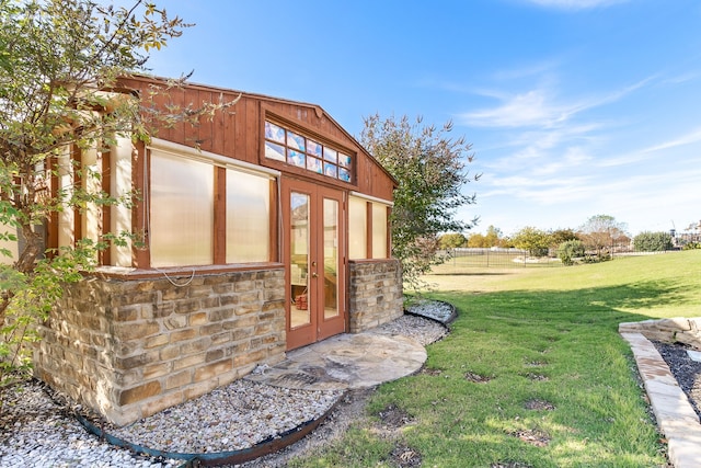 view of outbuilding featuring a lawn