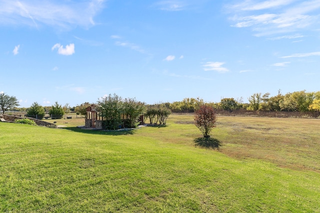 view of yard with a rural view