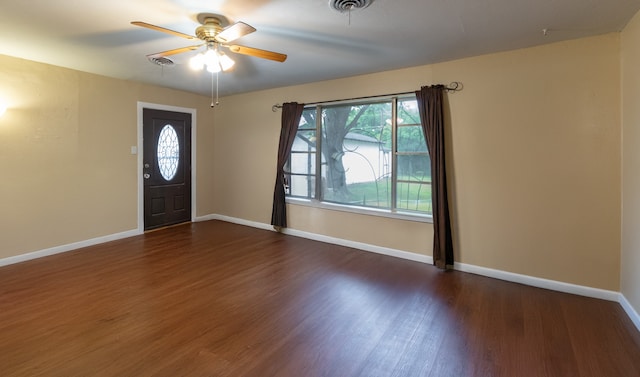 foyer with dark hardwood / wood-style flooring, a wealth of natural light, and ceiling fan