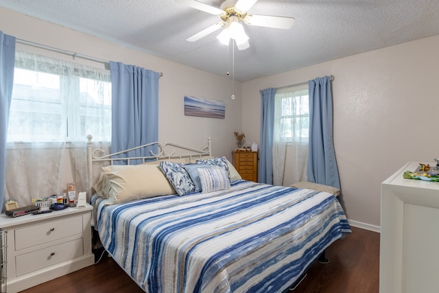 bedroom featuring a textured ceiling, dark hardwood / wood-style floors, and ceiling fan