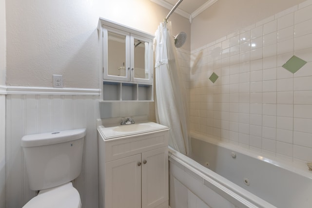 bathroom with toilet, a wainscoted wall, vanity, ornamental molding, and a combined bath / shower with jetted tub