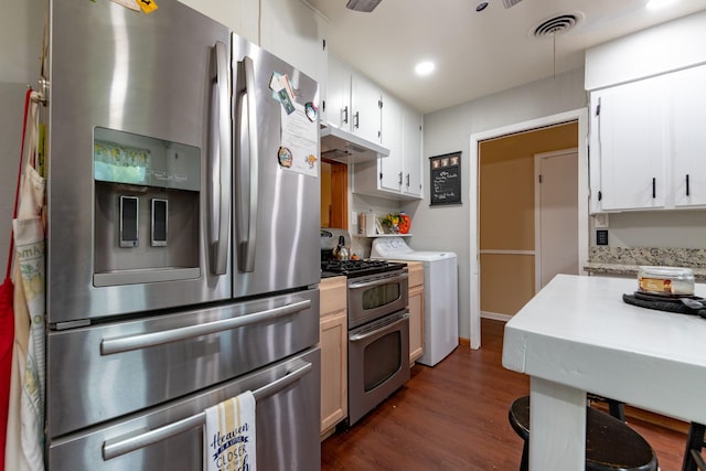 kitchen featuring under cabinet range hood, light countertops, appliances with stainless steel finishes, dark wood-style floors, and washer / clothes dryer