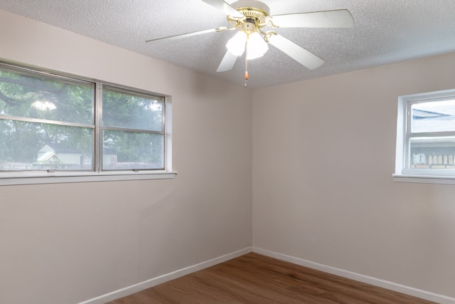 spare room featuring a ceiling fan, a textured ceiling, baseboards, and wood finished floors