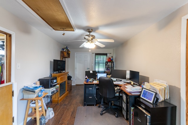 office with dark wood-style floors, ceiling fan, attic access, and baseboards