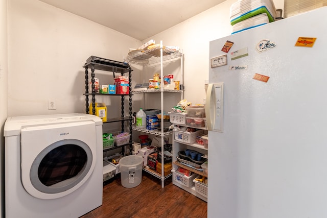 clothes washing area with laundry area, wood finished floors, and washer / dryer