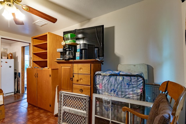 interior space with visible vents and freestanding refrigerator