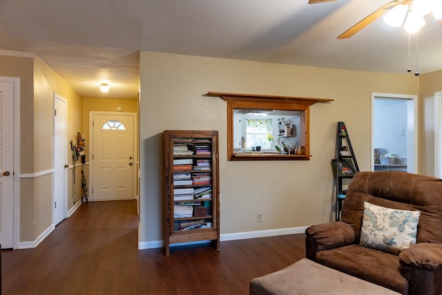 living area with ceiling fan, baseboards, and dark wood finished floors