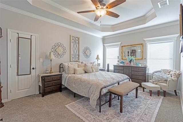 carpeted bedroom featuring a raised ceiling, ceiling fan, and crown molding