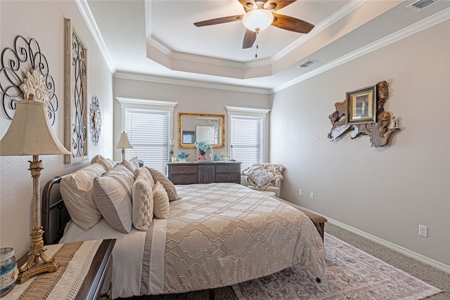 bedroom featuring carpet flooring, a raised ceiling, ceiling fan, and crown molding