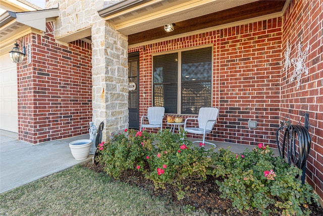 doorway to property with a porch and a garage