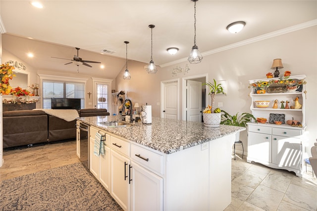 kitchen featuring a center island with sink, white cabinets, sink, ceiling fan, and stone countertops