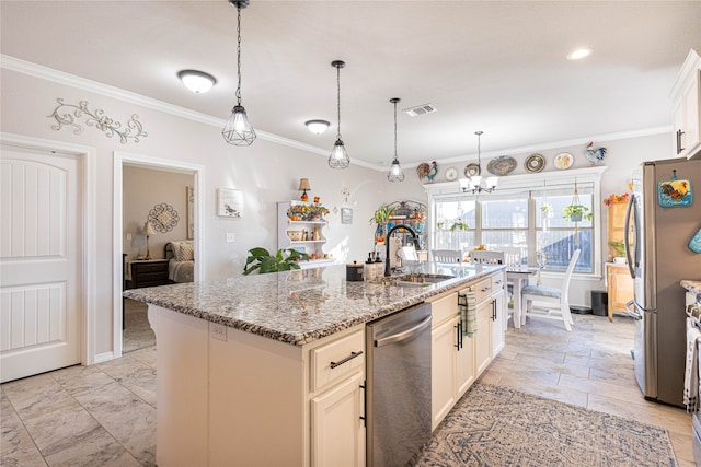 kitchen with appliances with stainless steel finishes, light stone counters, a kitchen island with sink, crown molding, and sink