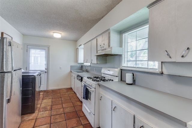 kitchen with white cabinets, plenty of natural light, white appliances, and sink