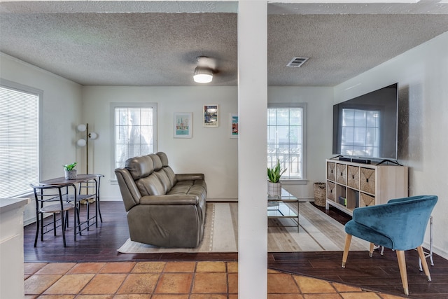 living room featuring wood-type flooring and a textured ceiling