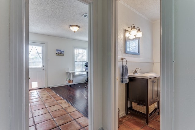 bathroom featuring a textured ceiling, vanity, hardwood / wood-style flooring, and crown molding