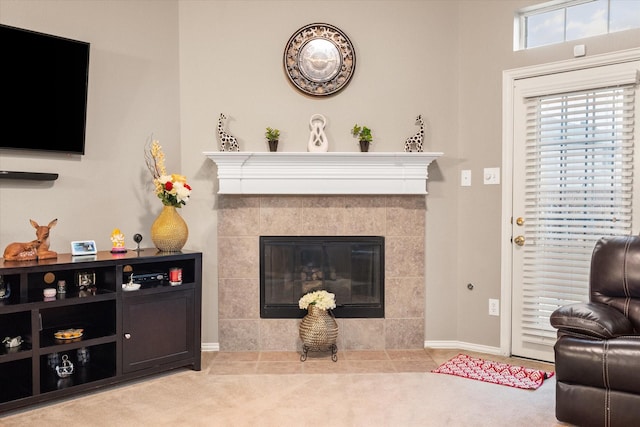 carpeted living room featuring a tiled fireplace