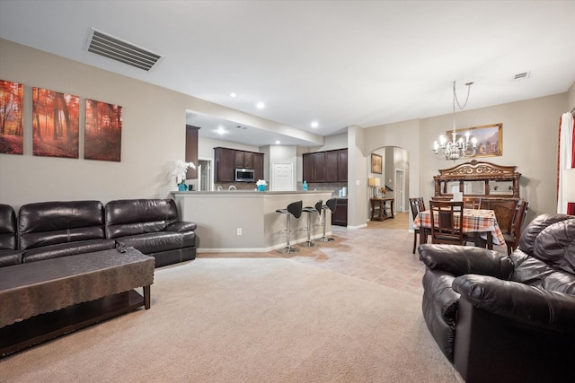 living room featuring light tile patterned floors and a notable chandelier