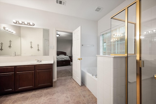 bathroom with tile patterned flooring, vanity, and independent shower and bath