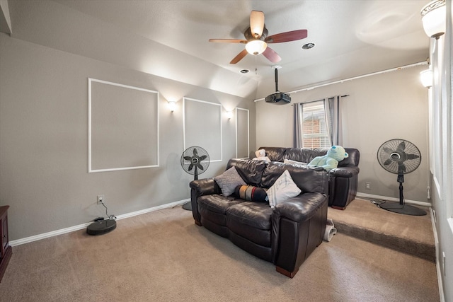 carpeted cinema room with vaulted ceiling and ceiling fan